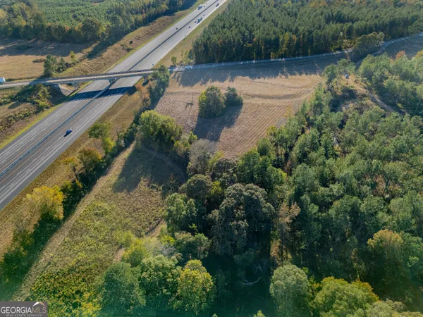 a view of a lake with a house and a yard