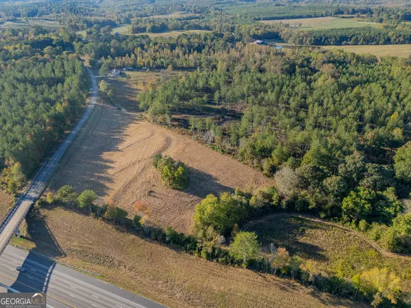 an aerial view of a house with a yard and lake view