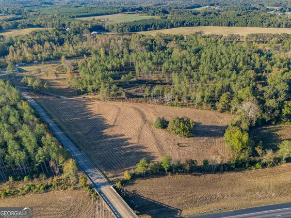 an aerial view of a house with a yard
