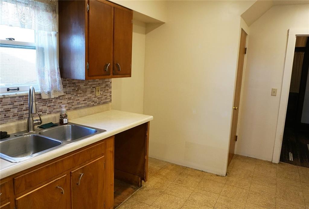 421 Ormsby Avenue Pittsburgh, PA 15210 - Photo 12 of 30 a kitchen with a sink and a refrigerator