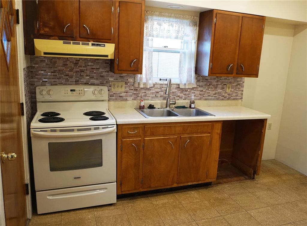 421 Ormsby Avenue Pittsburgh, PA 15210 - Photo 13 of 30 a kitchen with stainless steel appliances a stove a sink and a microwave