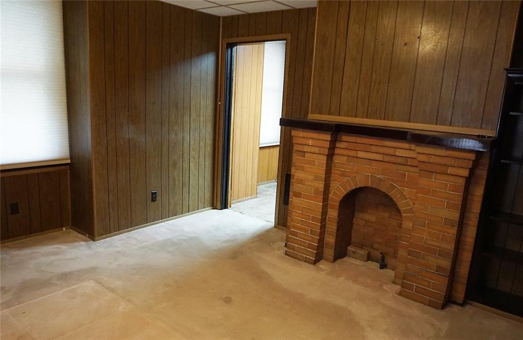 421 Ormsby Avenue Pittsburgh, PA 15210 - Photo 17 of 30 a view of an empty room with a fireplace and a window