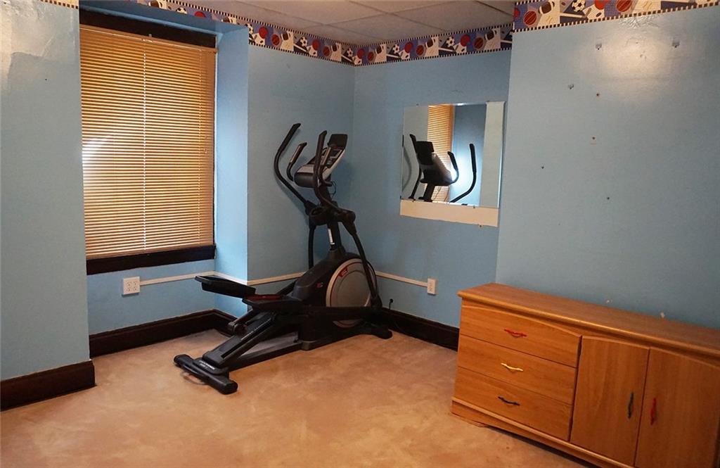 421 Ormsby Avenue Pittsburgh, PA 15210 - Photo 20 of 30 a room with gym equipment on wooden floor