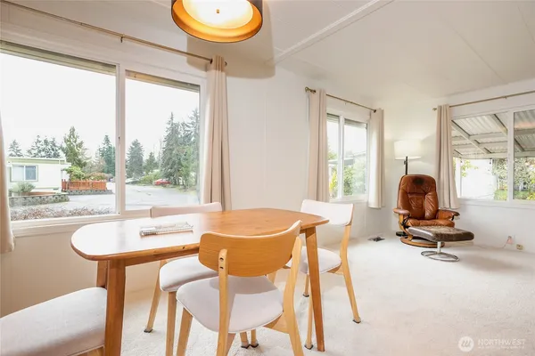 a dining room with wooden floor and a table