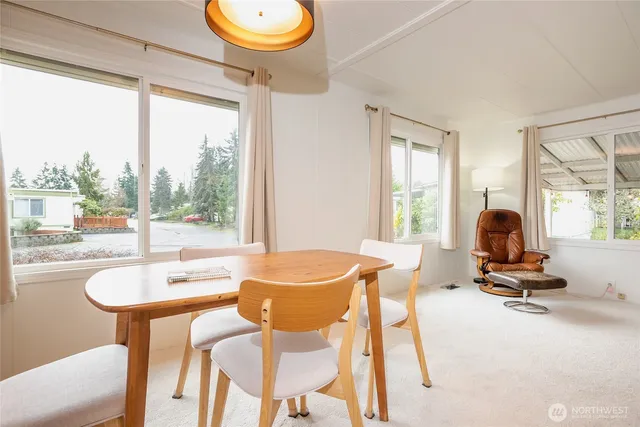 a dining room with wooden floor and a table