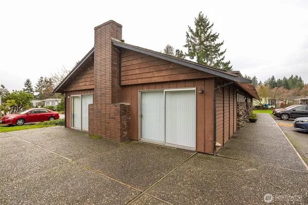 a view of a house with a patio and a yard