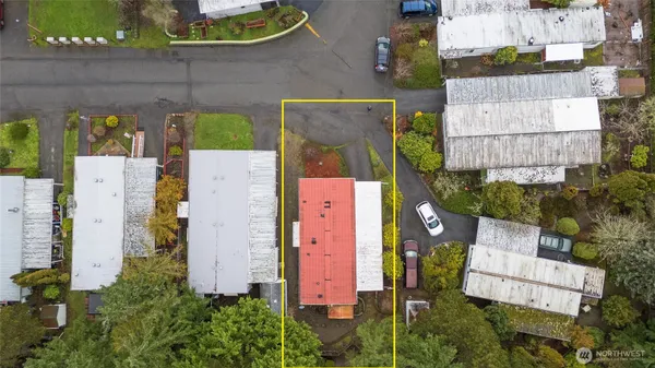 an aerial view of residential houses with outdoor space and parking