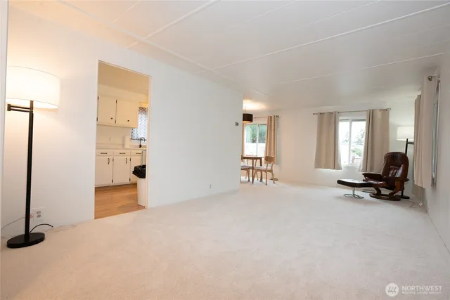 a view of empty room with furniture and windows