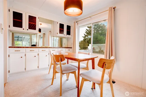 a dining room with furniture and window