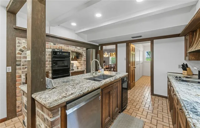 a kitchen with stainless steel appliances granite countertop a stove and a refrigerator