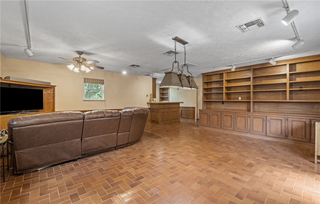 5222 Wooldridge Road Corpus Christi, TX 78413 - Photo 17 of 34 a living room with furniture a chandelier and a flat screen tv