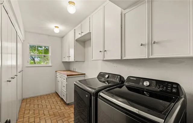 a kitchen with a stove and white cabinets