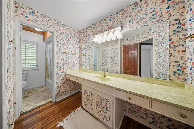 a bathroom with a granite countertop sink mirror and shower