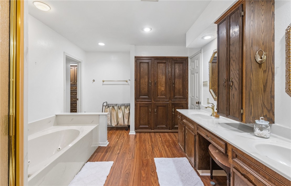 5222 Wooldridge Road Corpus Christi, TX 78413 - Photo 27 of 34 a bathroom with a double vanity sink a mirror and a bathtub