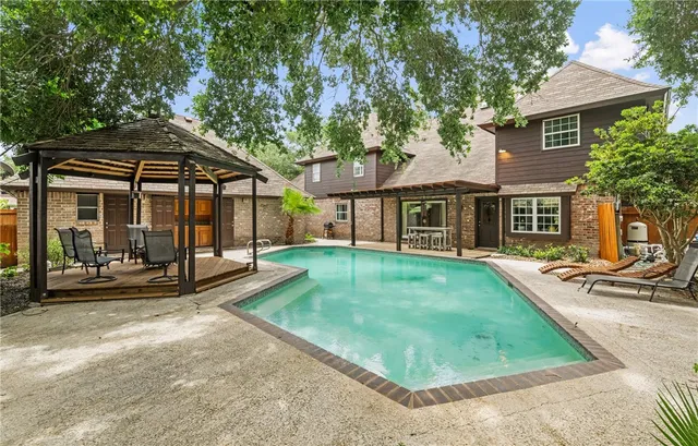 a view of a house with a yard and sitting area