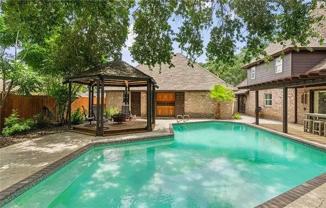 a view of a house with a yard patio and a small yard