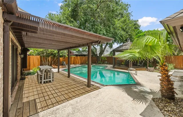 a patio with glass top table and chairs