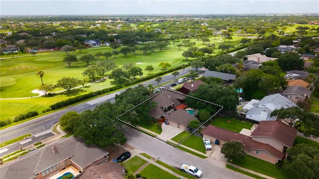 an aerial view of residential houses with outdoor space
