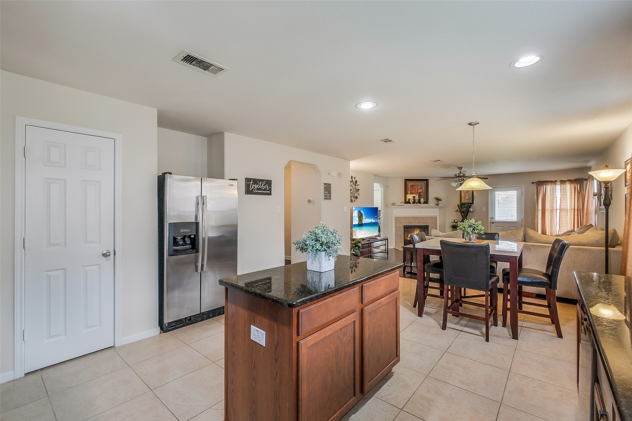 1015 Honeysuckle Vine Drive Rosenberg, TX 77469 - Photo 13 of 29 a kitchen with stainless steel appliances granite countertop a refrigerator and a dining table