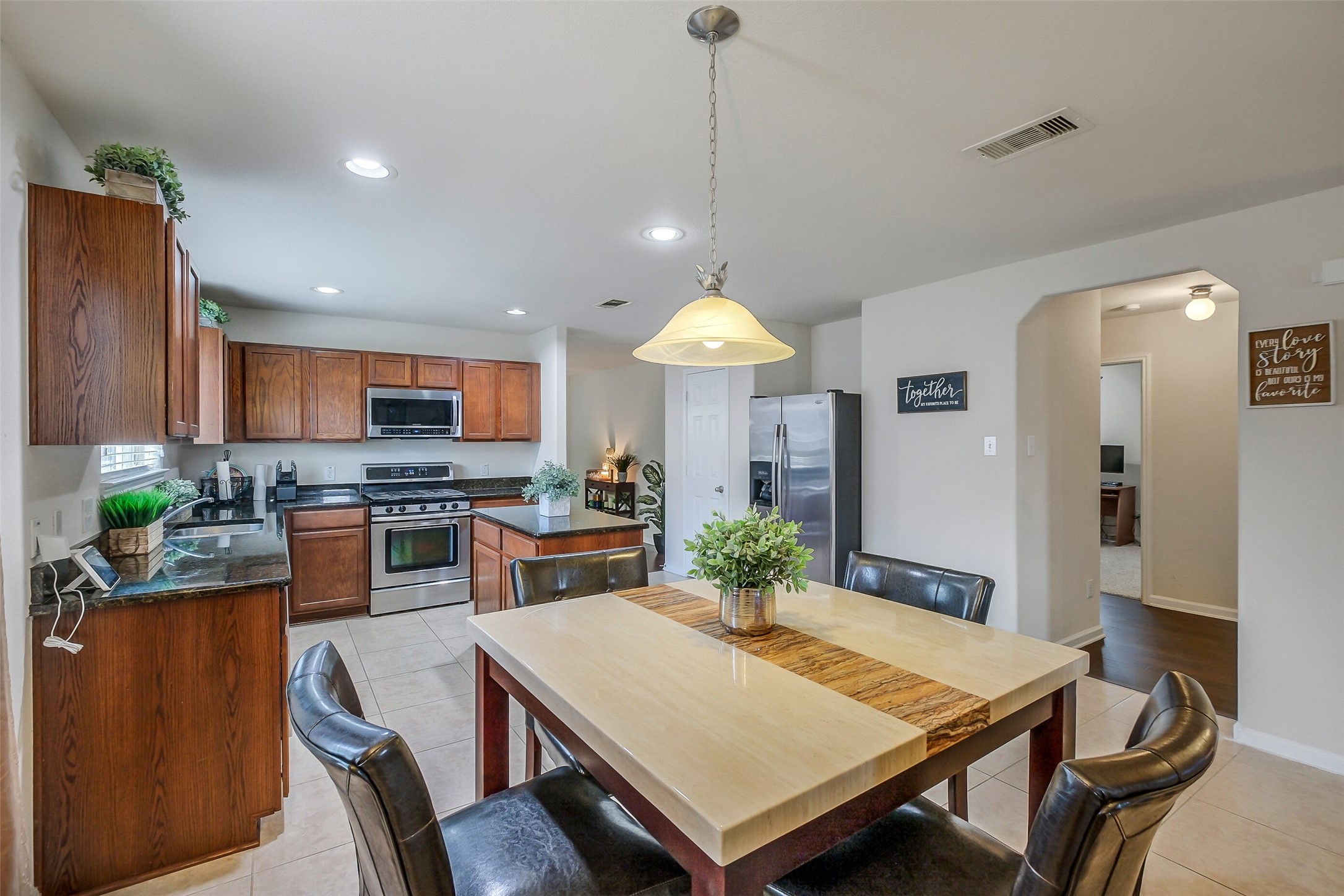 1015 Honeysuckle Vine Drive Rosenberg, TX 77469 - Photo 15 of 29 a kitchen with sink refrigerator dining table and chairs