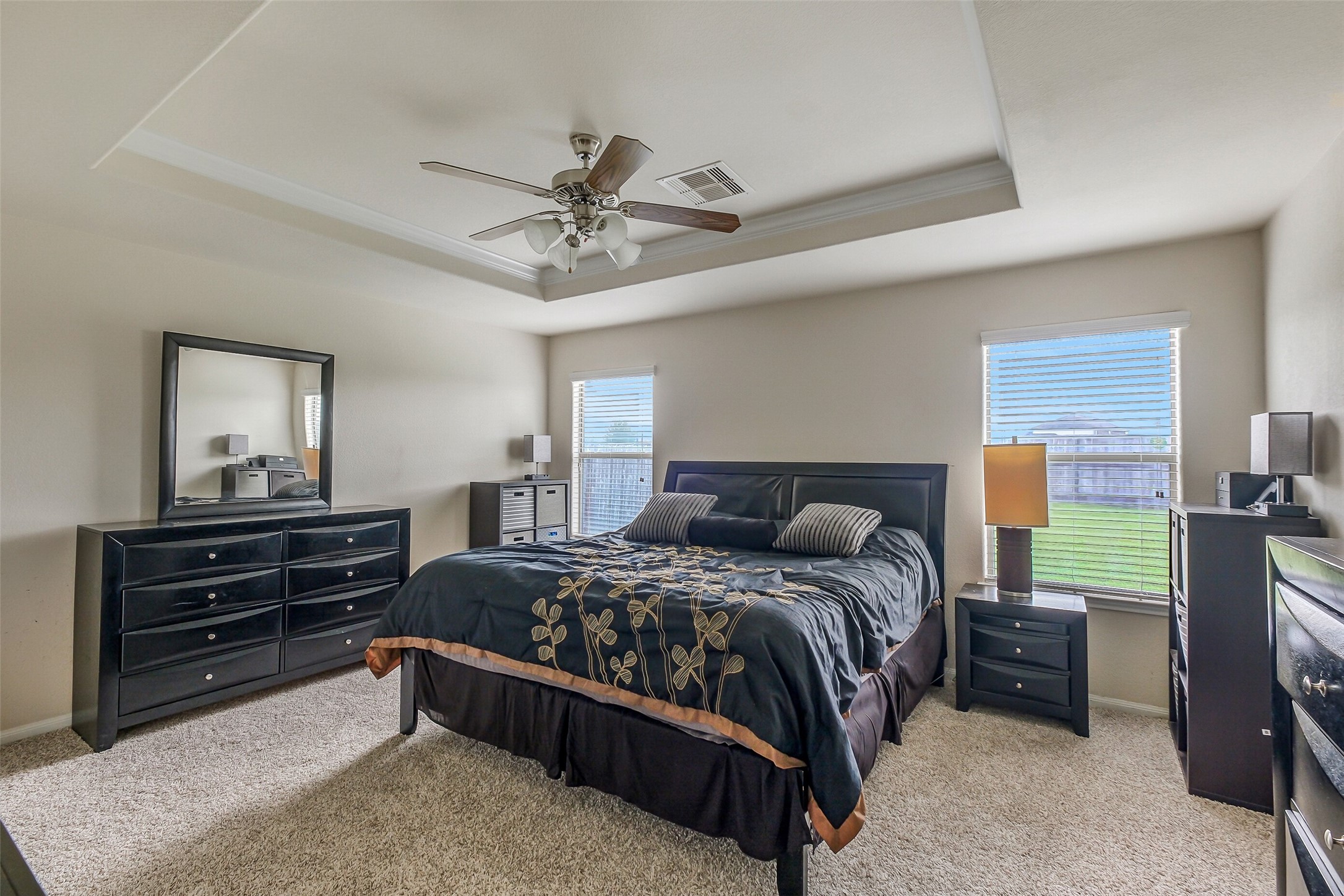 1015 Honeysuckle Vine Drive Rosenberg, TX 77469 - Photo 16 of 29 a bedroom with a bed and a chandelier