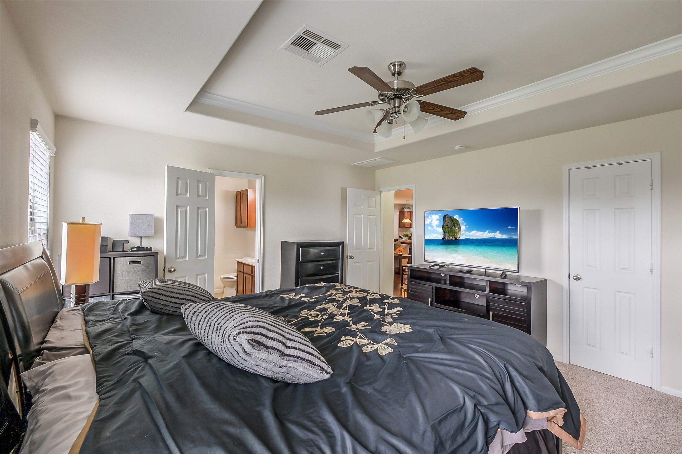 1015 Honeysuckle Vine Drive Rosenberg, TX 77469 - Photo 17 of 29 a bedroom with a bed and a flat screen tv