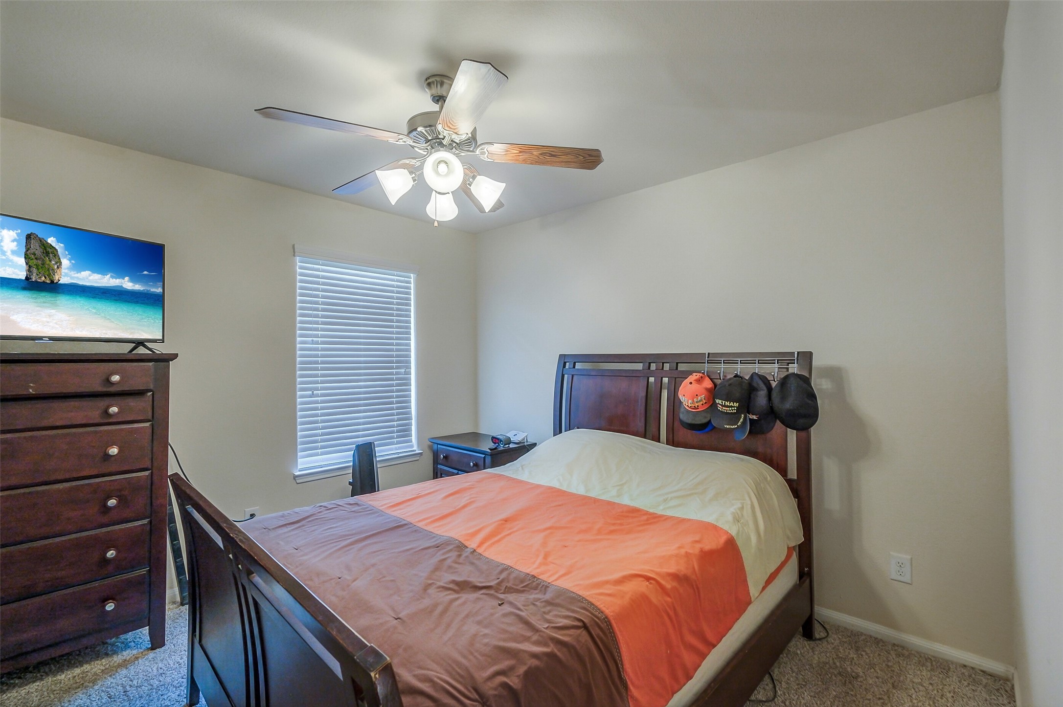 1015 Honeysuckle Vine Drive Rosenberg, TX 77469 - Photo 21 of 29 a bedroom with a bed and a chandelier