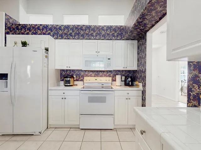 a kitchen with a sink window and cabinets
