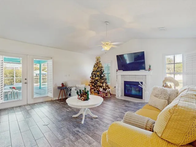 a living room with furniture a fireplace and a chandelier
