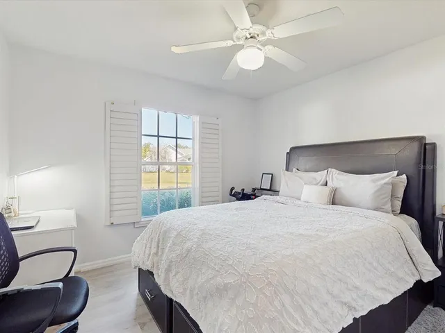 a bedroom with a large bed and a flat screen tv