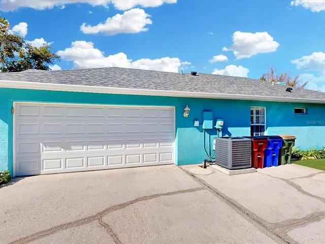 a view of a house with a backyard and a garage
