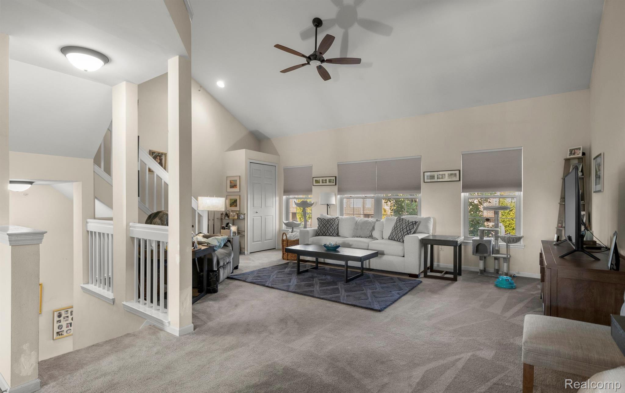 4242 Schaefer Road Dearborn, MI 48126 - Photo 2 of 18 Living area featuring carpet flooring, ceiling fan, and lofted ceiling