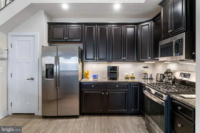 a kitchen with a sink and a wooden floor
