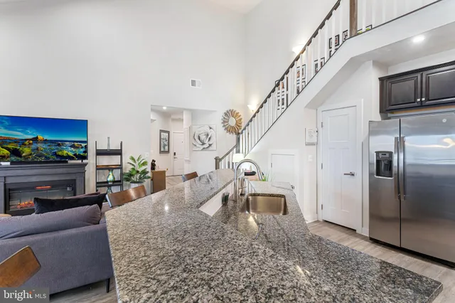 a living room with fireplace furniture and a chandelier