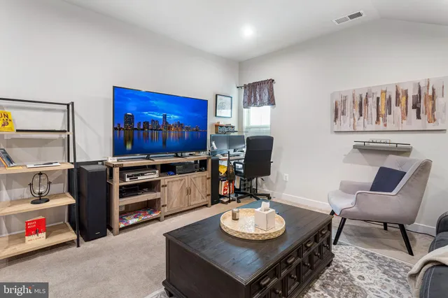 a living room with furniture and a book shelf