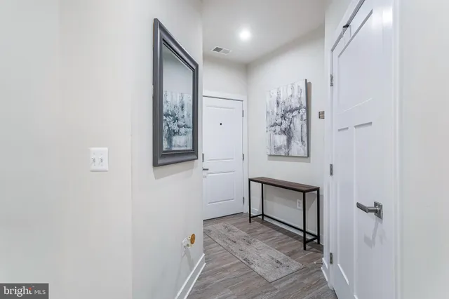 a living room with lots of furniture and kitchen view