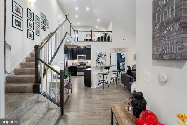 a view of entryway livingroom and hall with wooden floor