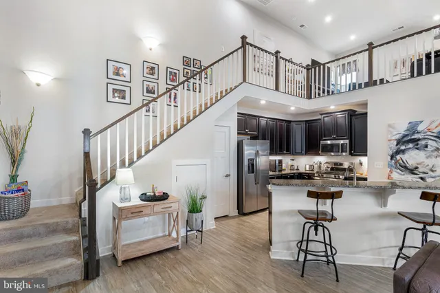a kitchen with stainless steel appliances kitchen island a chandelier