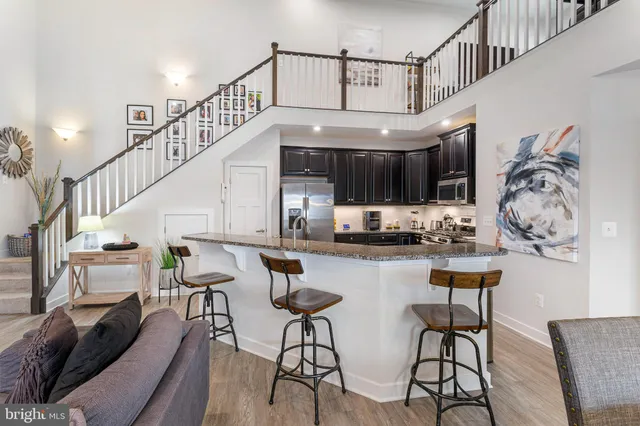 a kitchen with stainless steel appliances granite countertop a refrigerator and a sink