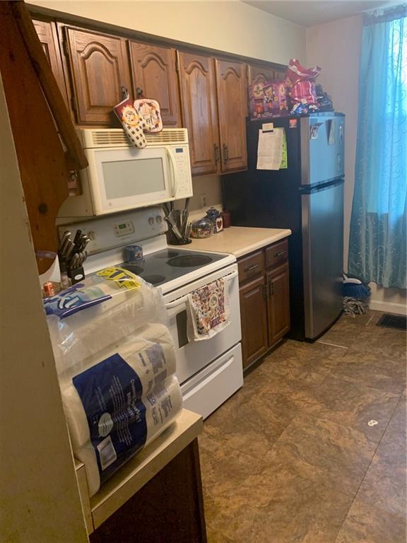 451 Delaware Avenue Rochester, PA 15074 - Photo 11 of 19 a kitchen with a stove and a refrigerator