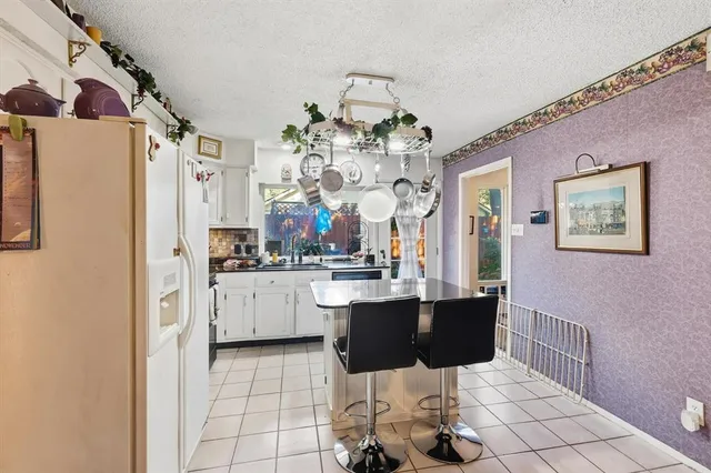a kitchen with stainless steel appliances granite countertop a sink and cabinets