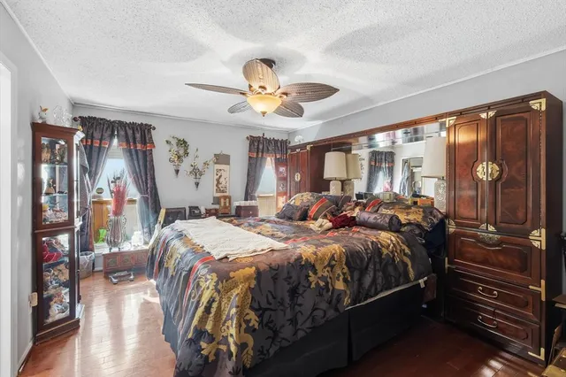a bedroom with a large bed and a chandelier