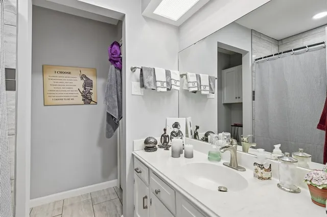 a living room with furniture a flat screen tv and a window