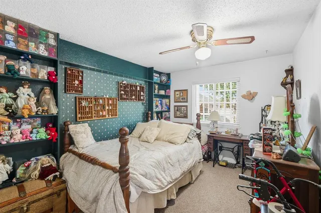 a bedroom with bed and a chandelier