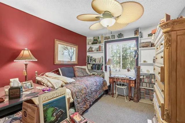 a view of a chair and table in backyard of the house