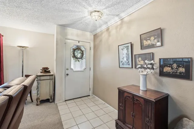 a view of a hallway with workspace and a window