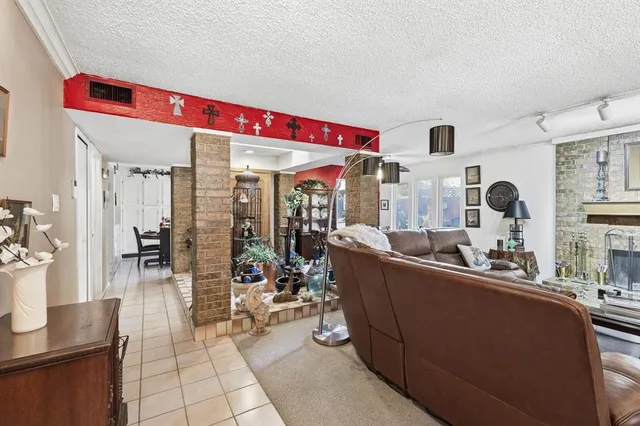 a living room with lots of furniture and painting on the wall