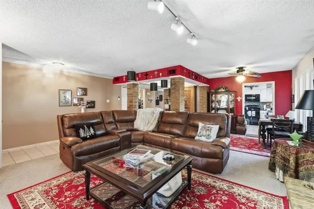 a living room with furniture a rug and a chandelier