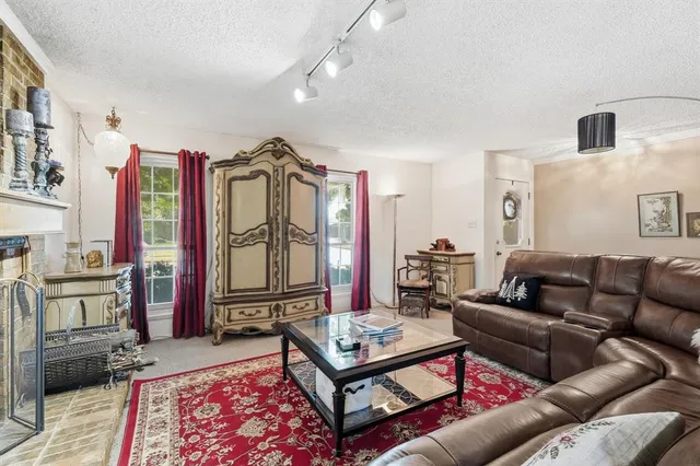 a living room with furniture a rug and a chandelier
