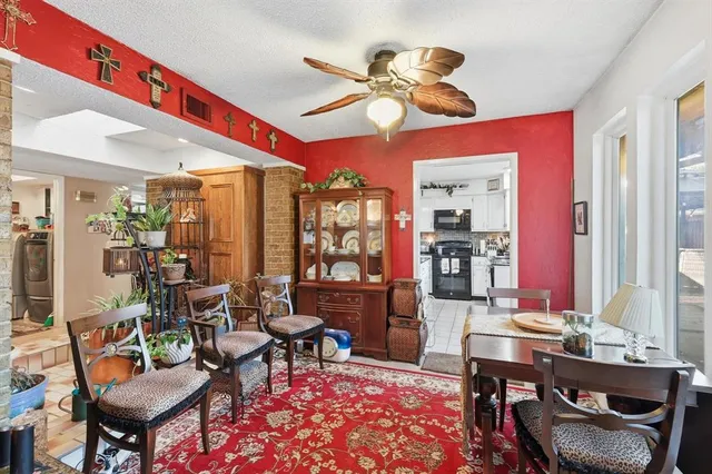 a living room with furniture a chandelier and a piano